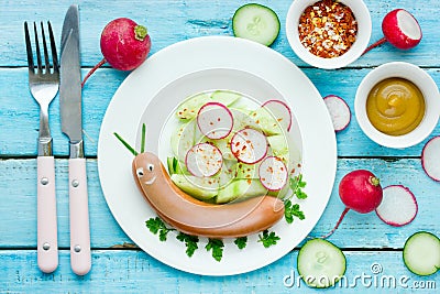 Funny food idea for kids - cute snail from sausage with vegetables Stock Photo