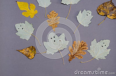 Funny ghosts drawn on the leaves of a poplar tree Stock Photo