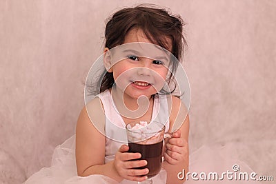 funny girl in ballerina tutu with a glass of hot drink in her hands Stock Photo