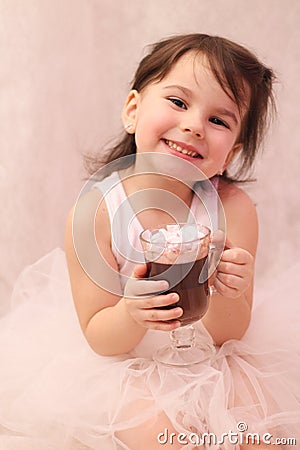 funny girl in ballerina tutu with a glass of hot drink in her hands Stock Photo