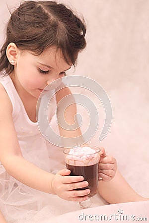 funny girl in ballerina tutu with a glass of hot drink in her hands Stock Photo