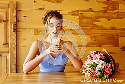 Funny girl drinking through a straw cappuccino Stock Photo