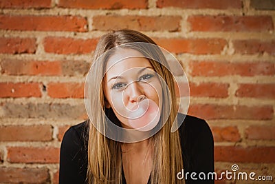 Funny girl making a pomp with a bubble gum Stock Photo