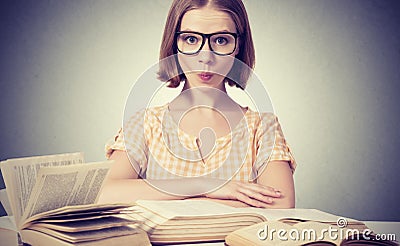 Funny girl student with glasses reading books Stock Photo