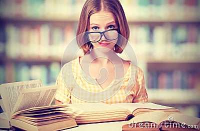 Funny girl student with glasses reading books Stock Photo