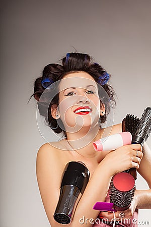 Funny girl styling hair holds many accessories Stock Photo