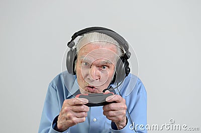 Funny grandfather playing a video game on console Stock Photo