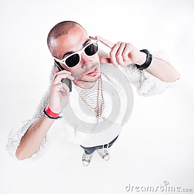 Funny guy wearing fur and hipster glasses while talking on the phone Stock Photo