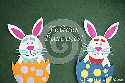 Funny handmade cartoon rabbits placed inside eggs and text in Sp Stock Photo