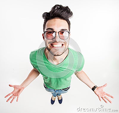 Funny handsome man with hipster glasses showing his palms and smiling large - wide angle shot Stock Photo