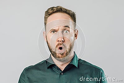 Funny handsome young man with surprised face expression Stock Photo