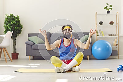 Funny happy man in retro sportswear sitting in easy yoga pose and learning to meditate Stock Photo