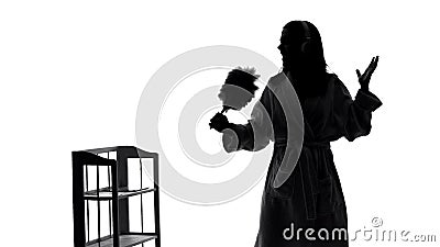 Funny housewife with headphones cleaning her room and singing song, shadow Stock Photo
