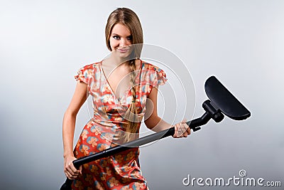 Funny housewife with vacuum cleaner Stock Photo