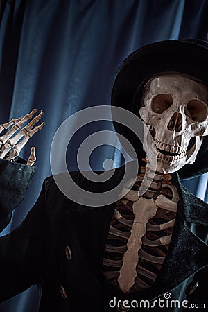 Funny human skeleton in a jacket and bowler hat. Stock Photo