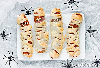 Funny idea for kids for Halloween food - sausage in dough as a m Stock Photo