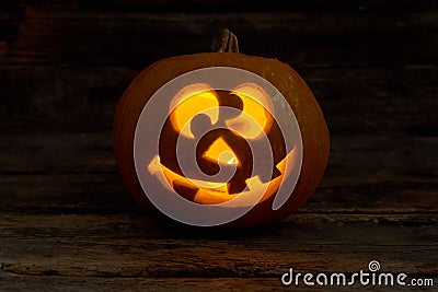 Funny Jack-O-Lantern with glowing candle. Stock Photo