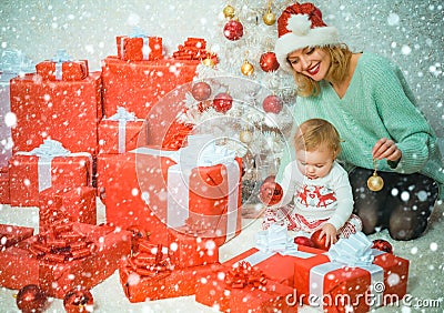 Funny kid baby with mom and Christmas gift. Christmas kids. Child with a Christmas present gift. Cute little kids Stock Photo