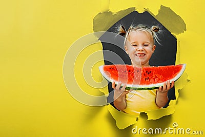 Funny kid eating watermelon outdoors on the gray backgrounds Stock Photo