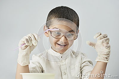 Funny kid making experiments at the workshop and exploring the world of chemistry Stock Photo