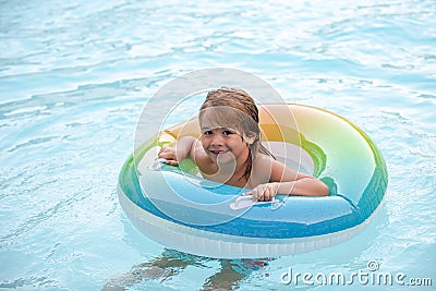 Funny kid in swimming pool. Child summertime holiday vacation. Boy at swimmingpool. Childhood. Stock Photo