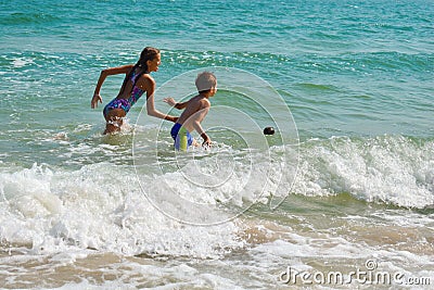 Funny kids playing in sea. The boys splashing in sea water. Family vacation in the tropics. Children play in ocean. Stock Photo