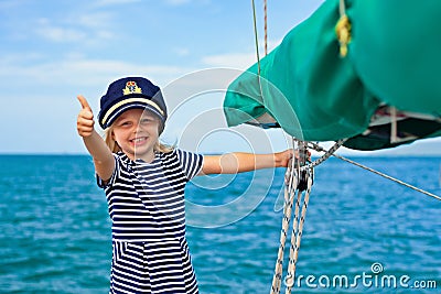 Funny little baby captain on board of sailing yacht Stock Photo
