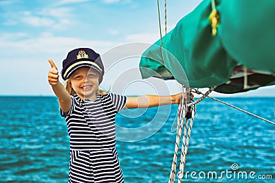 Funny little baby captain on board of sailing yacht Stock Photo