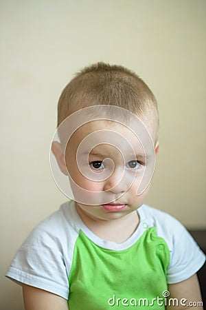 Funny little boy showing emotions, looking serious. Caucasian child 2 years old. Closeup portriat. Stock Photo