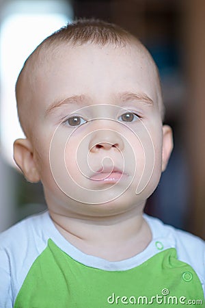 Funny little boy showing emotions, looking serious. Caucasian child 2 years old. Closeup portriat. Stock Photo