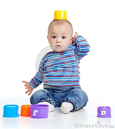 Funny little child is playing with cup toys Stock Photo