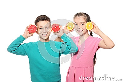 Funny little children with citrus fruits on white background Stock Photo