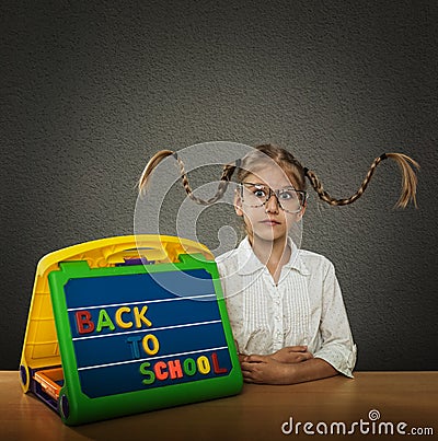 Funny little girl with braided hair up, big glasses Stock Photo