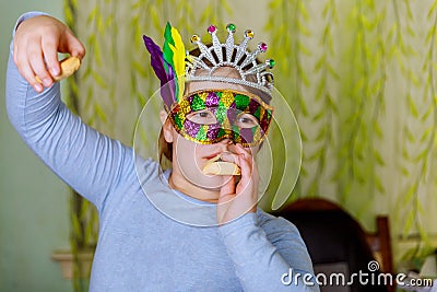 Funny little girl day party Purim celebration concept with carnival mask Stock Photo