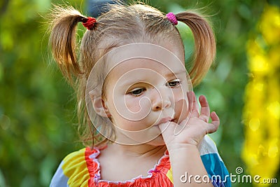 Funny little girl in the park Stock Photo