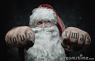Funny mad Santa Claus showing tattoos Stock Photo