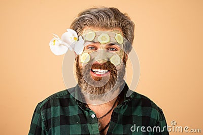 Funny man applied facial masks and cucumbers on face. Funny surprised and crazy comic concept. Facial beauty treatment. Stock Photo