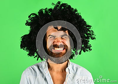 Funny man in black wig. Man with beard and mustache in curly periwig. Bearded hipster in black curly afro wig Stock Photo
