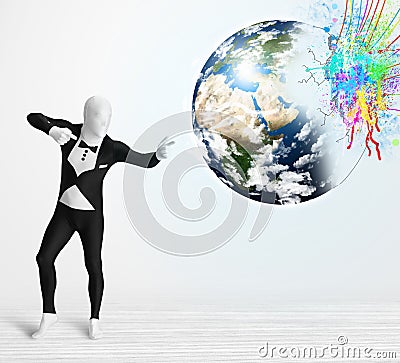 Funny man in body suit looking at colorful splatter earth Stock Photo