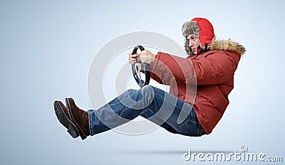 Funny man in cap driving a car in winter Stock Photo