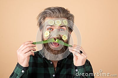 Funny man with clean fresh skin mask. Facial beauty treatment. Surprised and crazy comic concept. Stock Photo