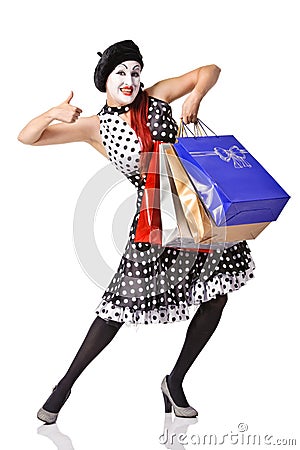 Funny mime in spotty dress holding shopping bags Stock Photo