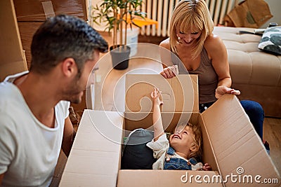 Funny moving to a new house - family moves boxes into a new house Stock Photo