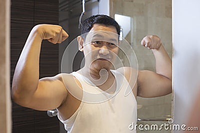 Funny Narcissist Male Smiling Looking at Himself in Mirror Stock Photo