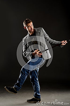 Funny negligent young man with walking stick Stock Photo