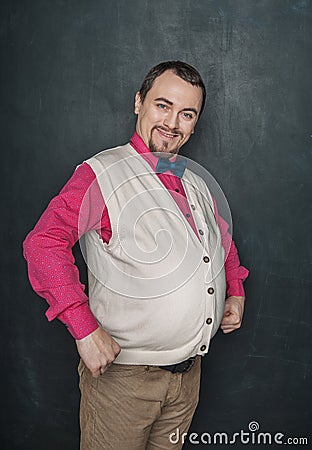 Funny nerd vintage style man flexing his muscle on blackboard Stock Photo