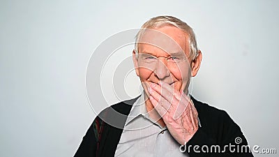 Funny old man laughs covering mouth with hand. stock video Funny old man laughs covering mouth with hand. stock video