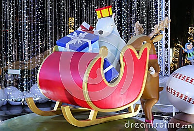 Funny Outdoor Christmas Decorations of a Reindeer Pushing Sleigh Full of Presents and a Polar Bear Stock Photo