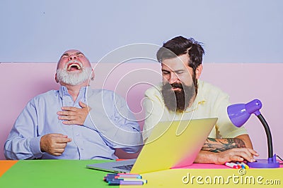 Funny photo of businessman wearing shirt working with laptop at table. Cheerful business men team of two people group Stock Photo