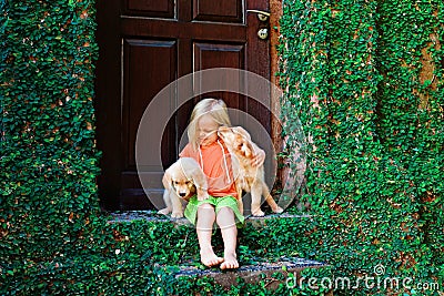 Funny photo of child cuddling beautiful golden labrador retriever puppy Stock Photo